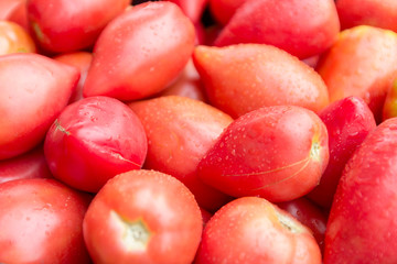 Ripe pink tomatoes /Thai pink egg tomato/ on stand at the marketplace. Selective focus.