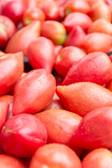 Ripe pink tomatoes /Thai pink egg tomato/ on stand at the marketplace. Selective focus.