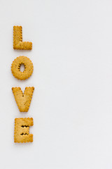 Love Lettering with Cookies on White Background. Top View Baked Letters Design Template.