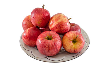 red apples in a plate isolated on white background. Side view.