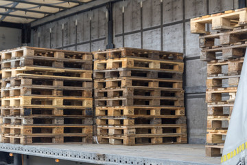 Wooden cargo pallets arranger at a truck.