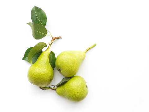 Green pears with leaves isolated on white background, top view