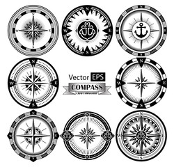 Set of vintage compasses with a wind rose and anchors. Freehand drawing.