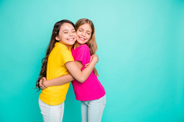 Photo of two hugging girls creating copyspace loving each other as best friends while isolated with...