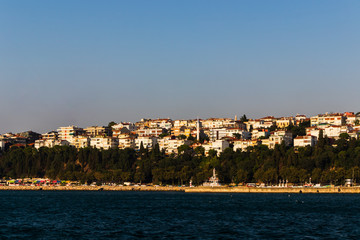 Fototapeta na wymiar distant view of buildings in Istanbul through the Bosporus or Bosphorus strait on a bright day