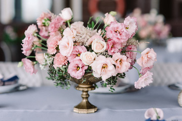 The luxury wedding bouquet on the holiday table adorns the table for guests