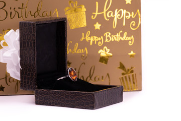 cinnamon stone ring in lather box with carry bag on white background. Happy birthday concept