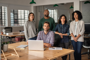 Focused team of diverse designers working together in an office