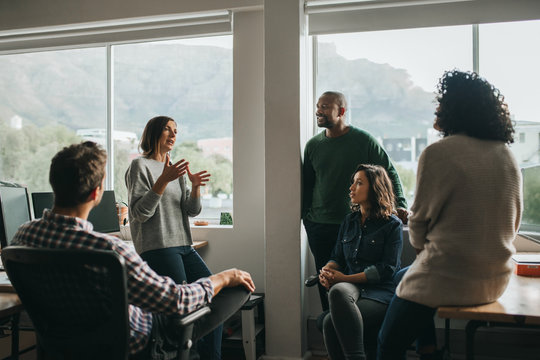Diverse designers discussing a project during an office meeting
