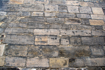 Background with a wall of old masonry with blackened stones