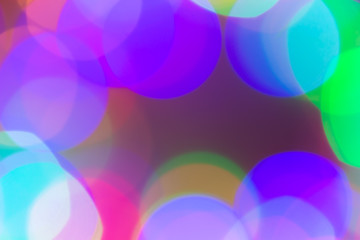 Blurred and defocused abstract multicolor background with christmas lights, soft multicolored bokeh circles