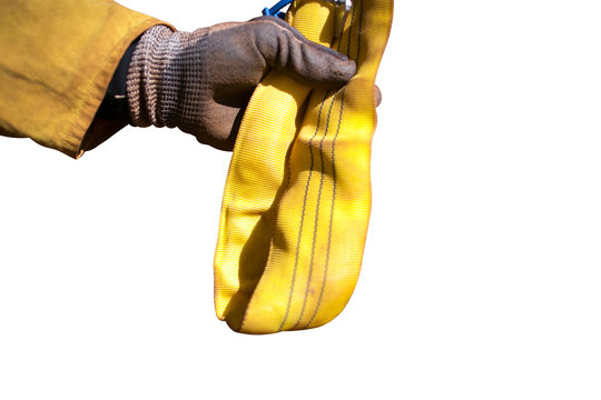 Rope access rigger high risk worker wearing heavy duty glove holding inspecting a yellow three tone crane lifting sling with isolated white background Sydney Construction building site, Australia 