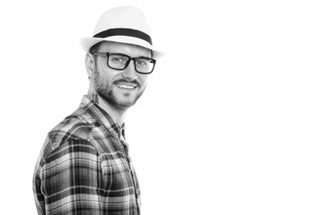 Studio shot of happy young man smiling and looking back