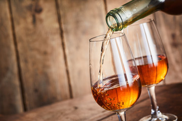 Rich golden sherry being poured into a wineglass