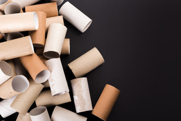 Empty Toilet Rolls Stack Up On a Black Background