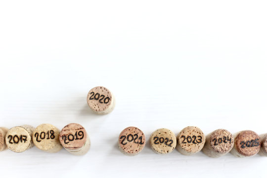 wine cork with the number 2020 pushed ahead of other corks with other numbers top view. upcoming new year