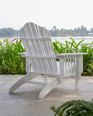 The white wood beach chair in the backyard