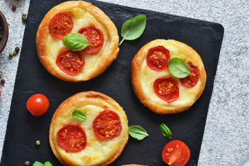 Mini pie with tomatoes and cheese. Quiche with vegetables and sauce top view.