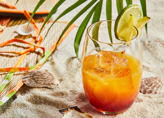 Glass of orange and rum blend cocktail with ice