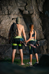 Couple of Young Climbers with the Rope near the Rock in the Mountains. Adventure and Extreme Sport Concept