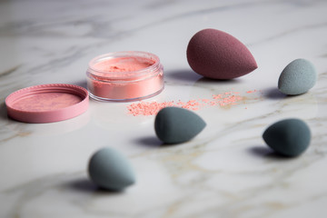 Obraz na płótnie Canvas Looses Rouge Puder Make-up mit Blender Schwamm auf Marmor Beauty Schminktisch