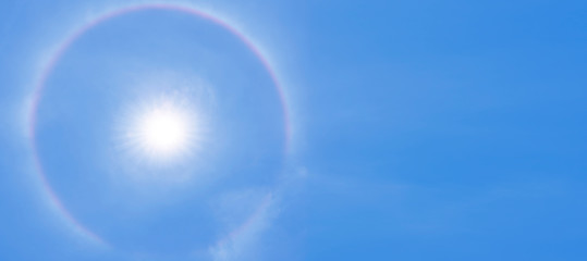 Beautiful abstract Sun halo and white cloud on dramatic blue sky in the summer
