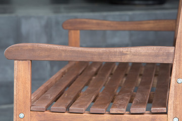 Obraz na płótnie Canvas The detail of brown wood bench in the backyard.