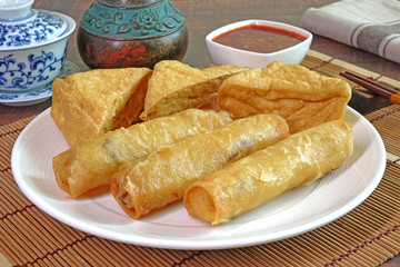 Vegetarian food : Deep fried crispy Spring rolls and fried Tofu, served with sweet and spicy chili sauce. Vegetarian festival. Selective focus