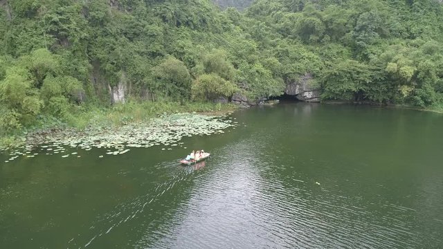 Stock footage 4k: Trang An rowboats cave tours with beautiful mountains view, Ninh Binh, Vietnam. Aerial view of Trang An - UNESCO World Heritage Site, one of the most popular destinations in Vietnam
