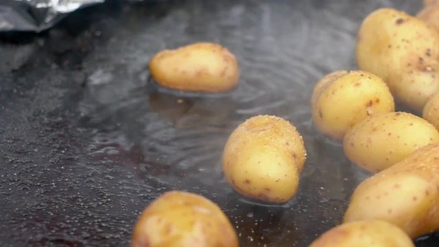Close up of sizzling potatoes on outdoor pan