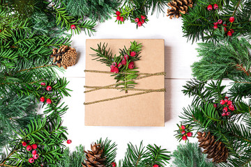 Fototapeta na wymiar Christmas gift box and fir tree branches on white.