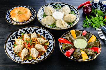 Fototapeta na wymiar Set of dishes of Uzbek cuisine , Manty, plov, dolma and lagman
