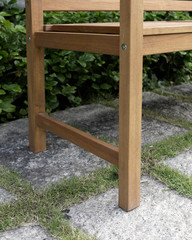 Fototapeta na wymiar The detail of wood bench in the backyard.