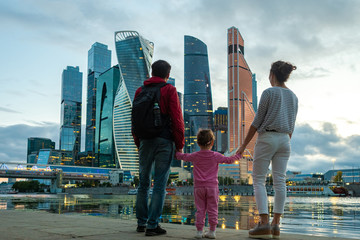 Moscow. Russia. Embankment of the Moscow river. The family admires the skyscrapers in the city...