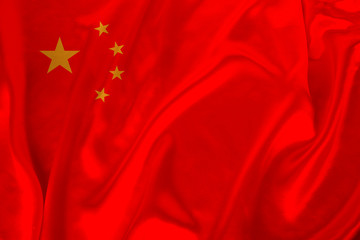 photo of the national flag of China on a luxurious texture of satin, silk with waves, folds and highlights, closeup, copy space, concept of travel, economy and state policy, illustration