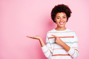 Photo of pretty dark skin wavy lady indicating finger on open palm advising new cheap product wear...