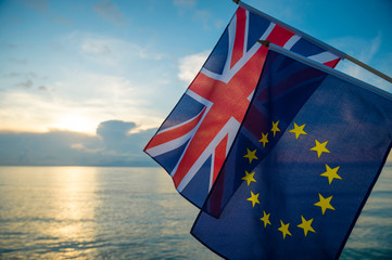 European Union and British Union Jack flags flying together as the sun rises on a new era on the...