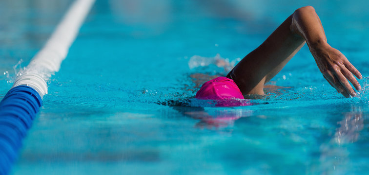 Swim competition swimmer athlete doing crawl stroke in swimming pool