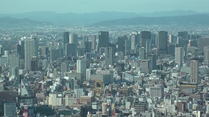 OSAKA, JAPAN - CIRCA SEPTEMBER 2019 : Aerial high angle view of CITYSCAPE of OSAKA in daytime. Osaka is the second largest metropolitan area in Japan. Zoom out shot.
