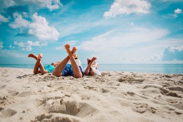 father with son and daughter relax on beach