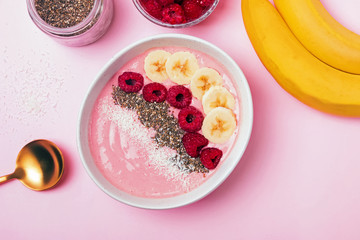 Delicious healthy smoothie bowl with bananas and raspberies