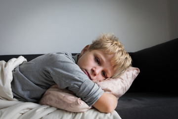 Sick child with fever at home, kid with headache, pain concept