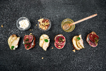 Bruschetta and Crostini with pear, ricotta cheese, honey, figs, nuts and herbs. Breakfast toasts or...