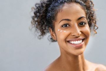 Beauty woman with moisturizer on face