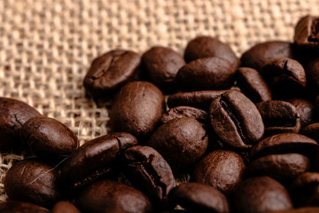 Coffee beans on burlap background