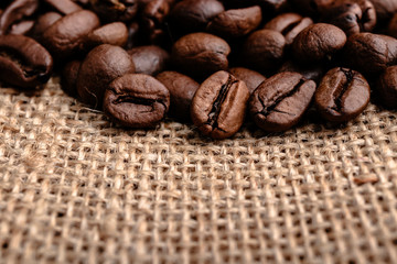 Coffee beans on burlap background