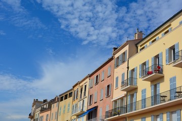 Fototapeta na wymiar Colored house facade in the historic center of Saint Tropez, France, with balconies