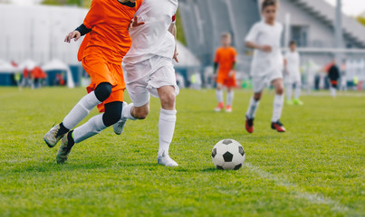 Football Game. Junior Level Boys Kicking Soccer Match on Grass. Youth Football Game. Children Sport...
