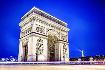Arch of Triumph in Paris at night with the lights of the cars