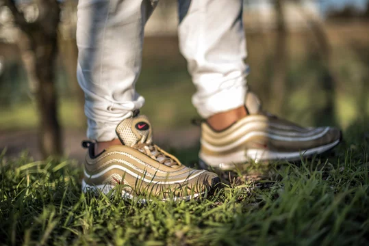 Air 97 Gold shoes in the street Stock Photo | Adobe Stock